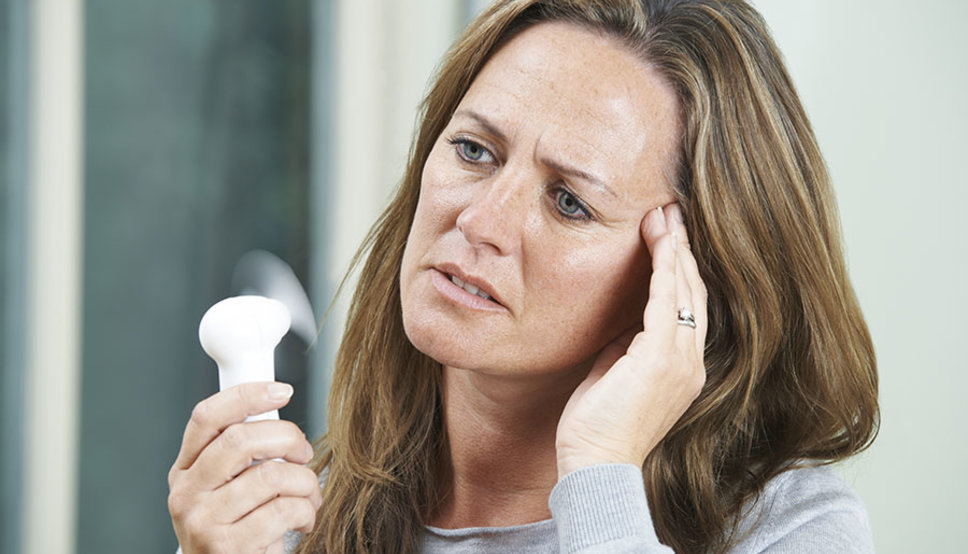 Mature Woman Experiencing Hot Flush From Menopause Mature Woman Experiencing Hot Flush From Menopause